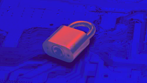 A padlock illuminated in red light sits atop a blue circuit board, symbolizing cybersecurity or digital data protection.
