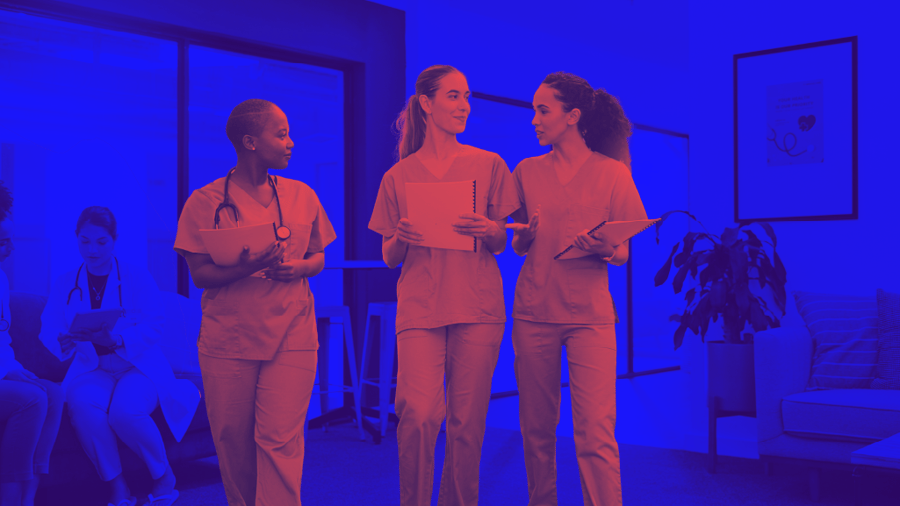 Three medical professionals in scrubs discussing notes in a hospital or clinic setting bathed in dramatic blue lighting, with additional staff visible in the background.