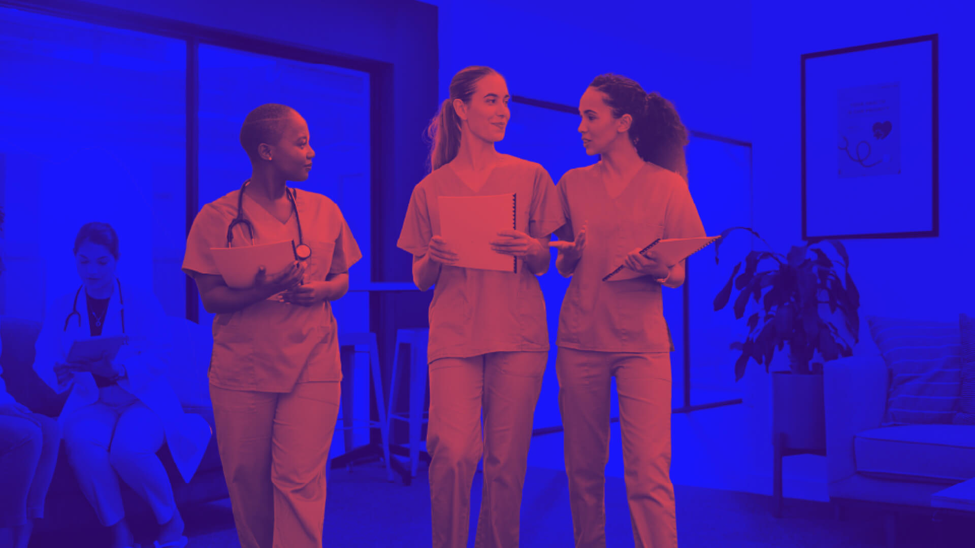 Nurses walking together through a hospital hallway